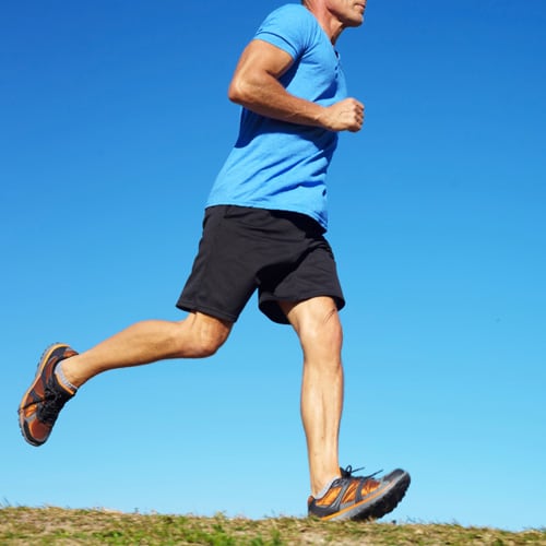 Athletic middle-aged man running from the waist down